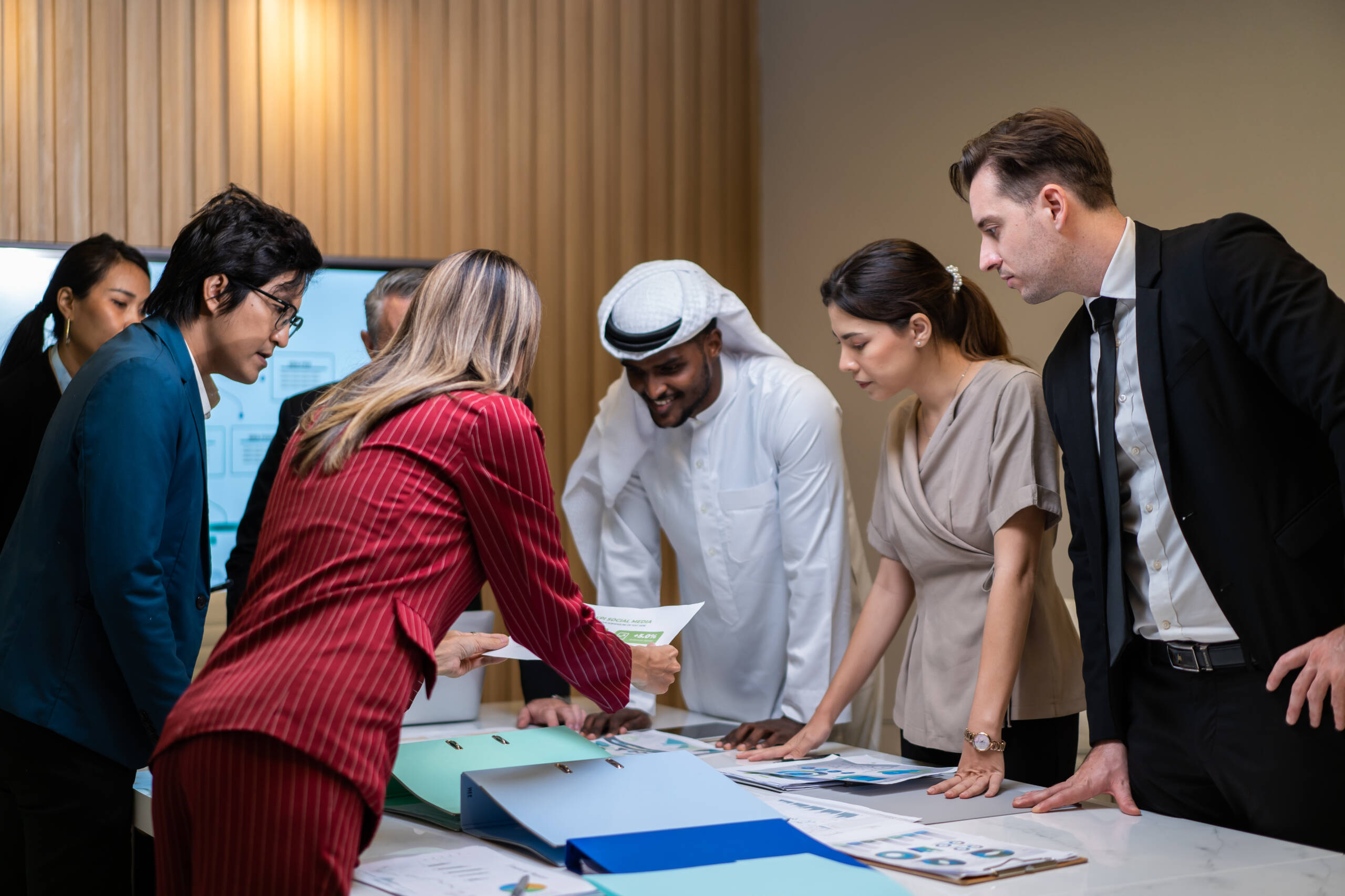 Group of multi-Ethnic businessman and businesswoman working in office. Attractive employee brainstorm and meeting as team, plan and discuss project in workplace. Corporate of modern colleagues concept